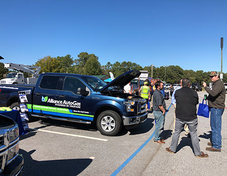 Alliance AutoGas Vehicle Ford Truck at Event with Attendees Looking Under Hood