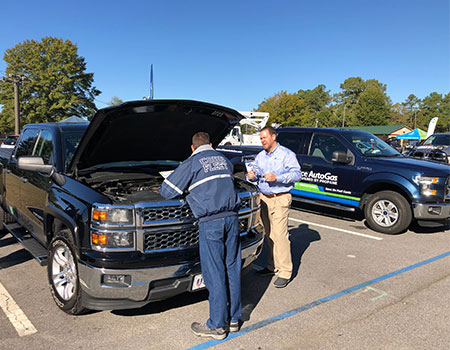 Alliance AutoGas Vehicle Ford Truck at Event with Attendees Looking Under Hood