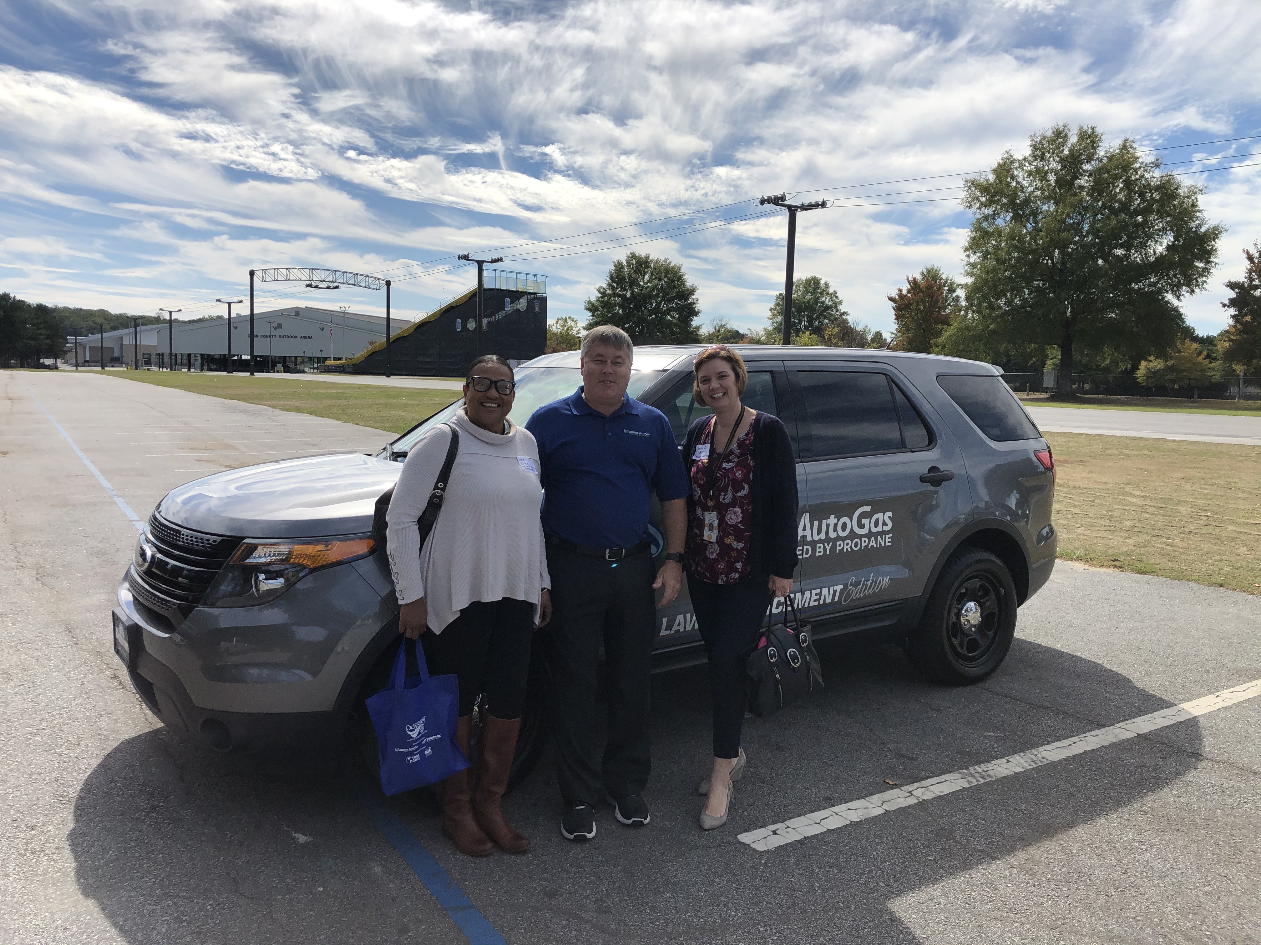 Three Individuals Standing infront of Alliance AutoGas vehicle in parking lot